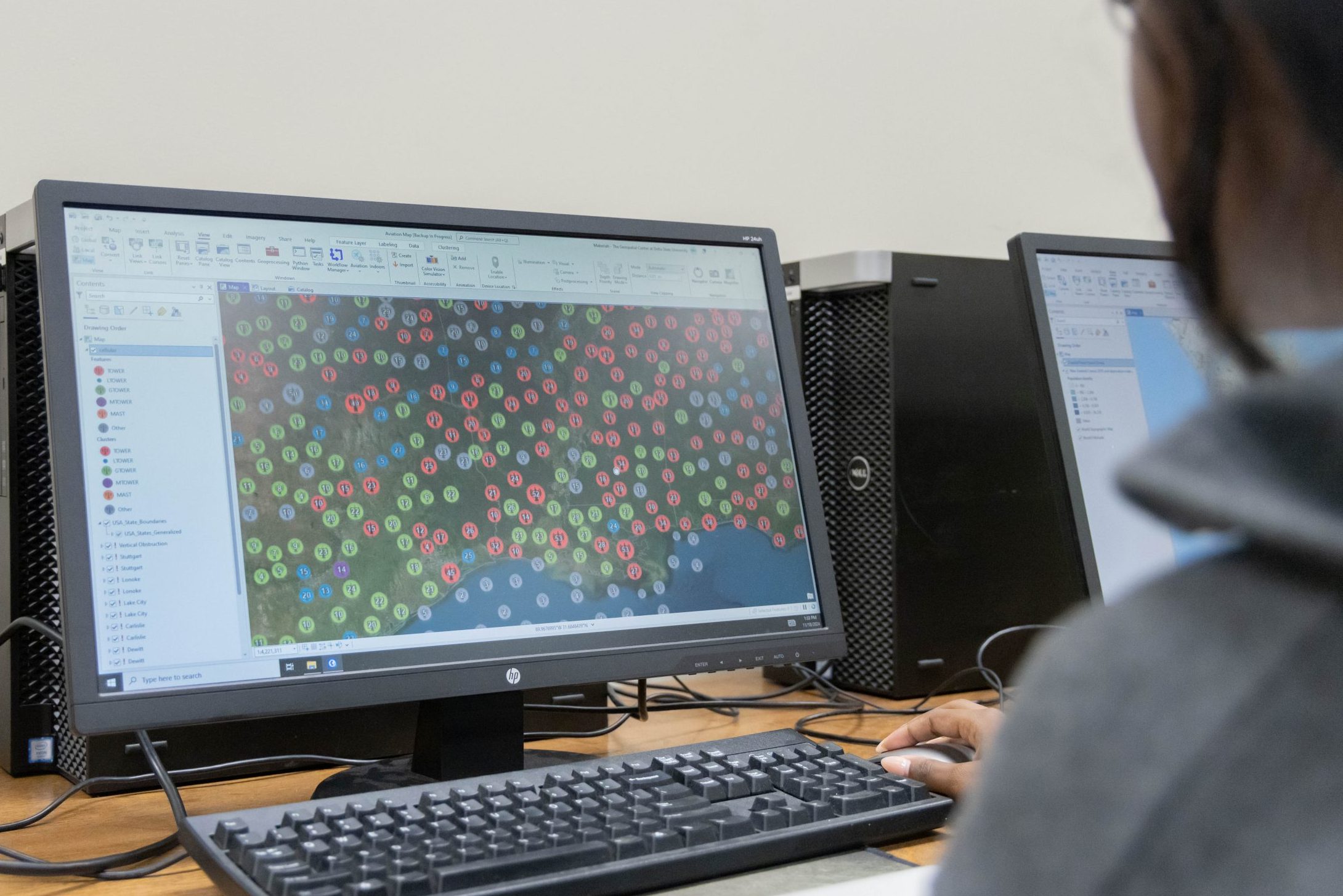 A computer screening showing a large database of plotted points on a geographic area in ArcGIS software.