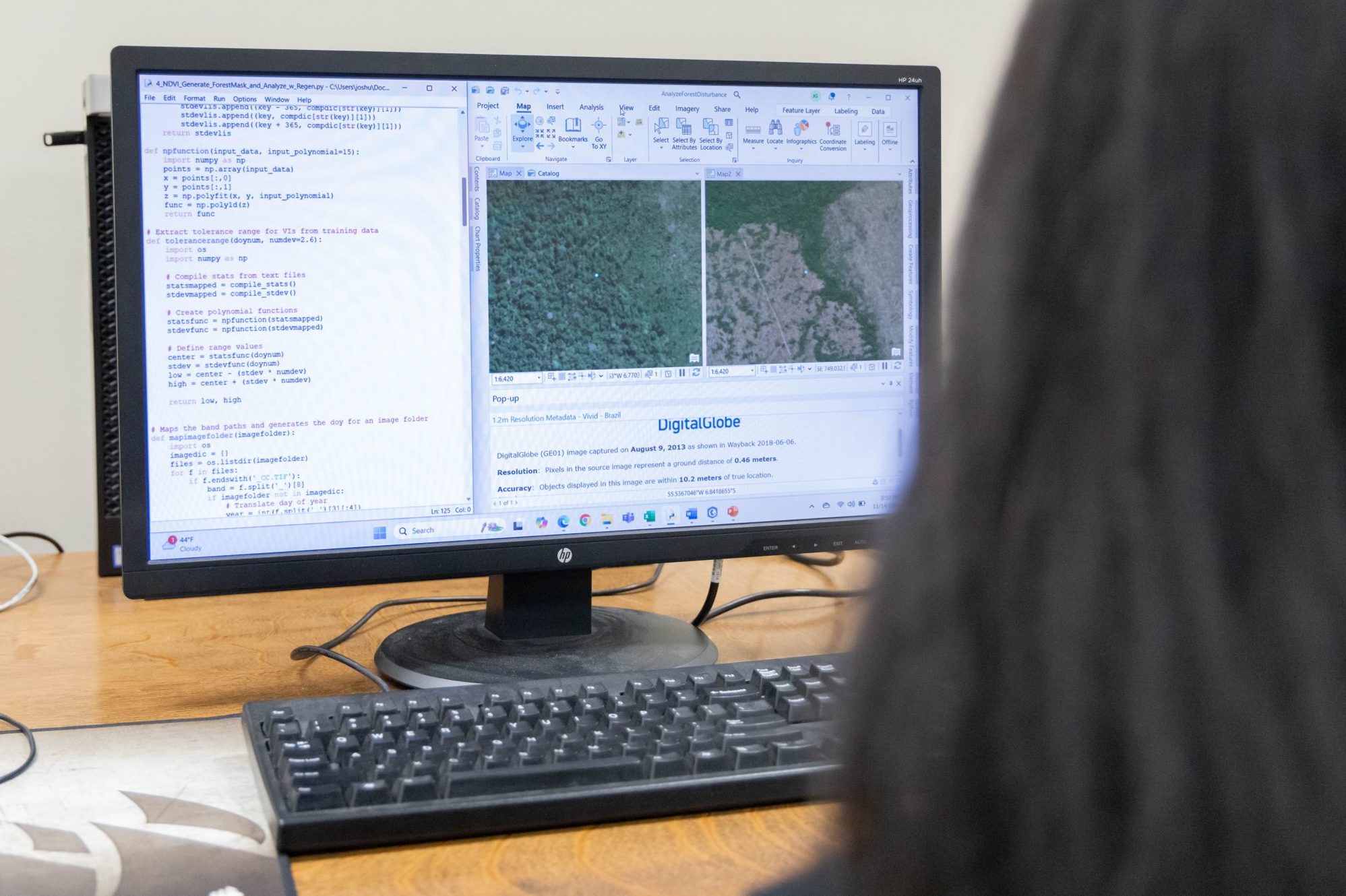 A computer screening showing satellite and aerial imagery with python coding in ArcGIS software.