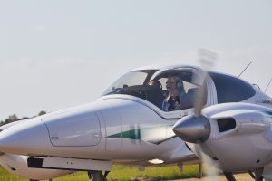 Student pilots seated inside a twin-engine training aircraft preparing for flight.