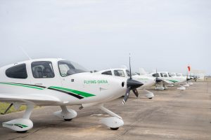Multiple Delta State University training aircraft lined up on the runway.