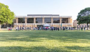 Students gather on the Delta State University Quadrangle in front of the Student Union during a campus egg hunt event.