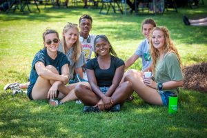Students smiling and hanging out on the University quadrangle.
