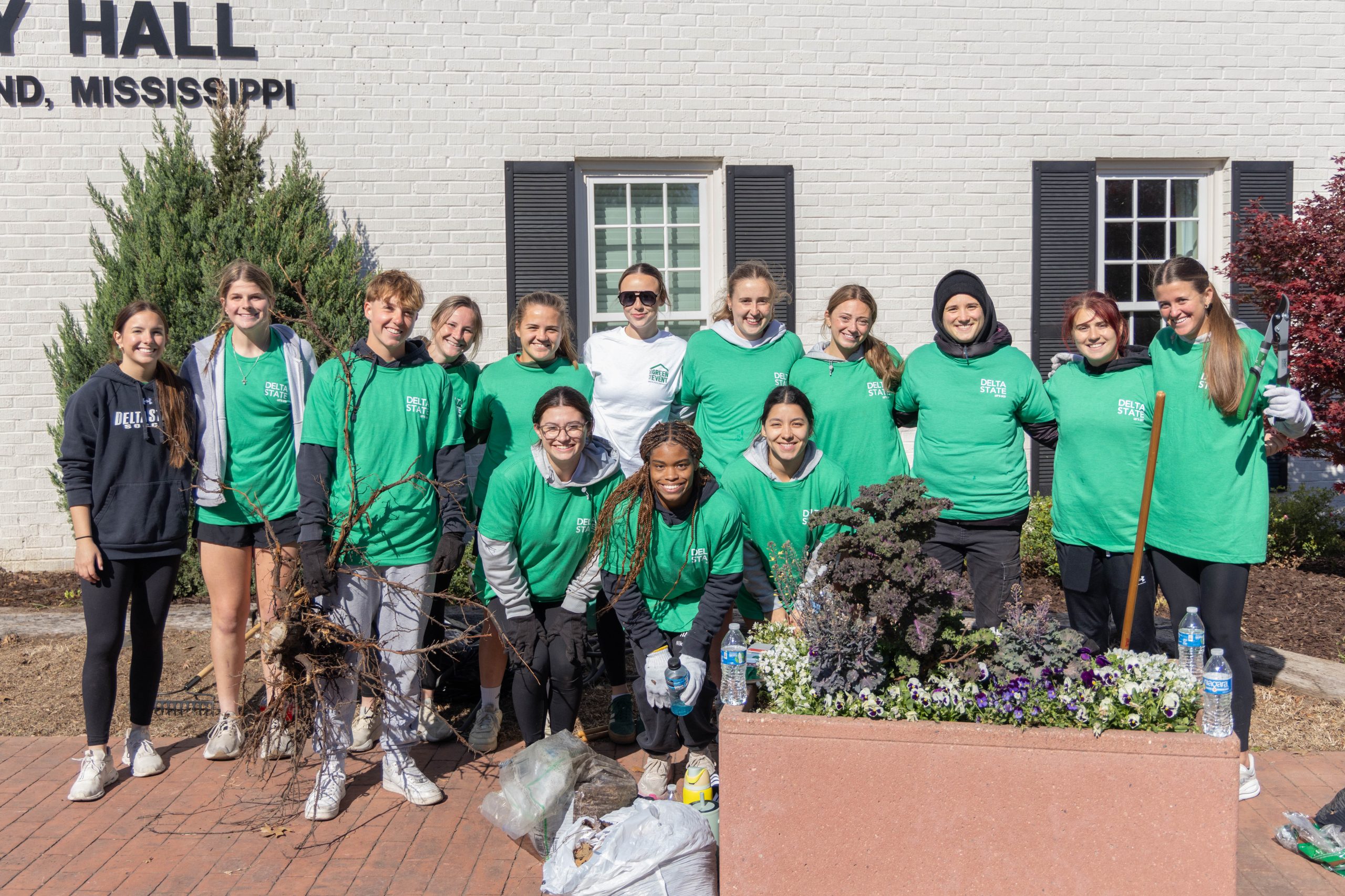 Several DSU students posing in front of Cleveland City Hall during the Big Green Event.