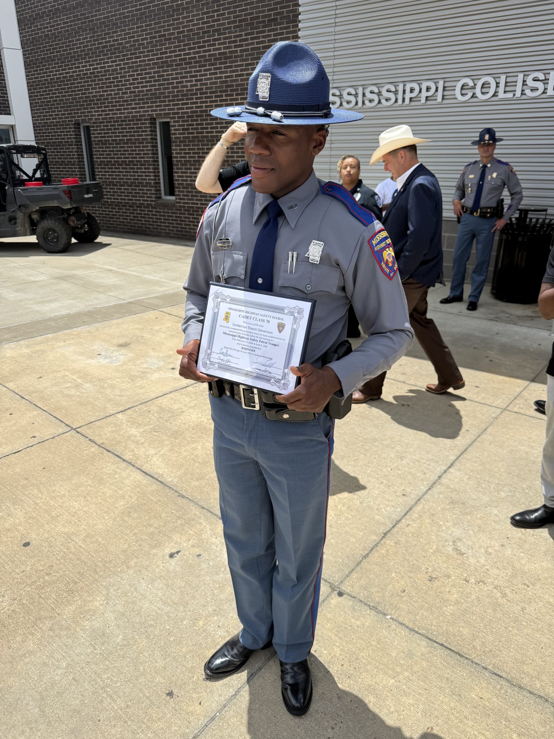 a Mississippi Highway Patrol Officer with his graduation certificate.