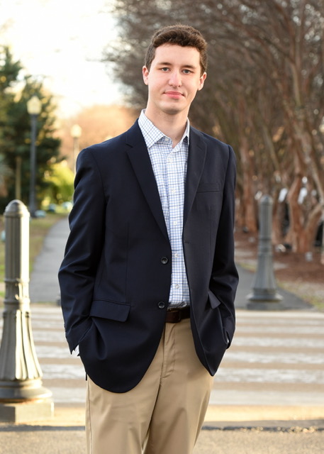 a young man in a blue blazer