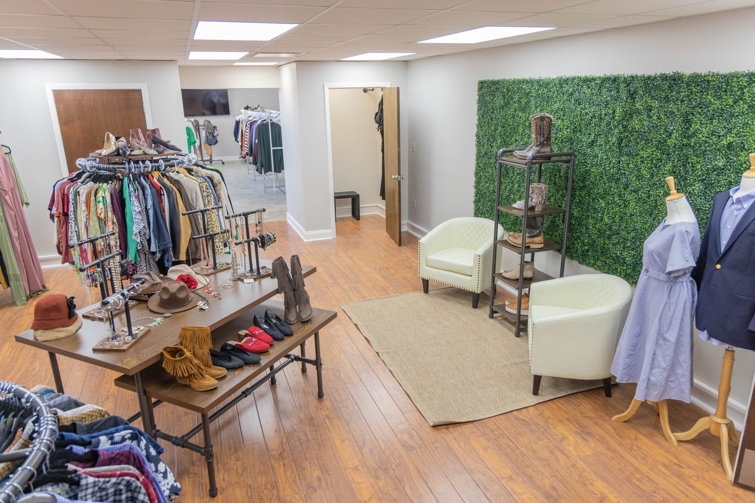 a room filled with clothing racks and shoe stands