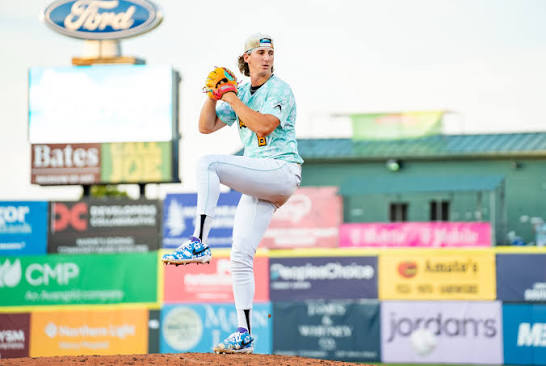 a right handed pitcher mid-delivery