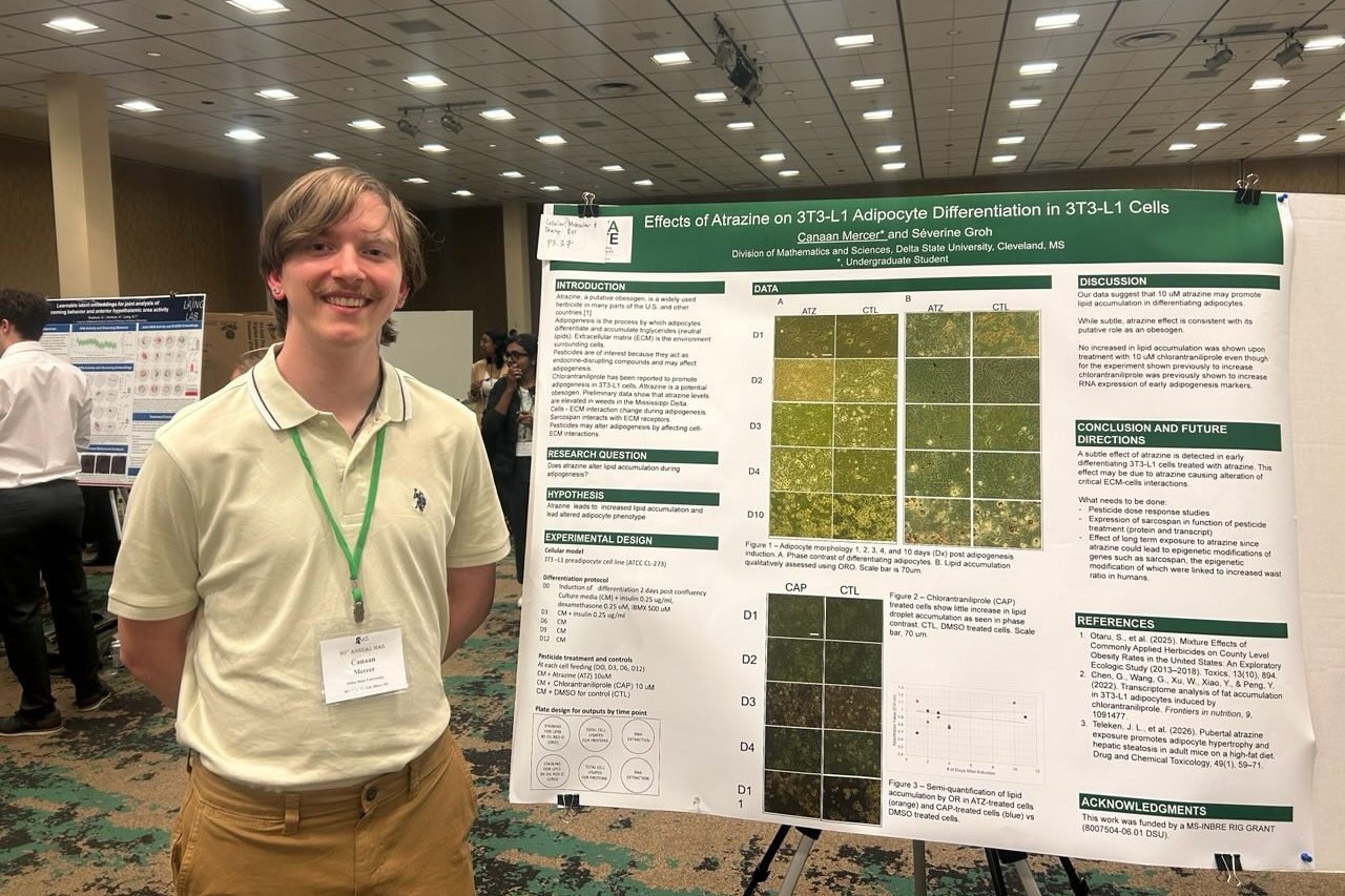 Delta State student presenting scientific research at a poster presentation.