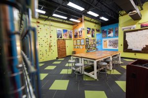 Outdoor recreation lab featuring climbing walls, ropes, worktables, and instructional equipment.