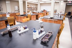 Chemistry teaching laboratory with workstations, laboratory equipment, and materials for student experiments.