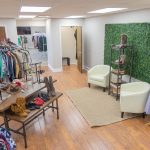 a room filled with clothing racks and shoe stands